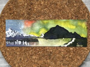 The front of a bookmark printed with Nikki's "Aurora Australis 1" painting.