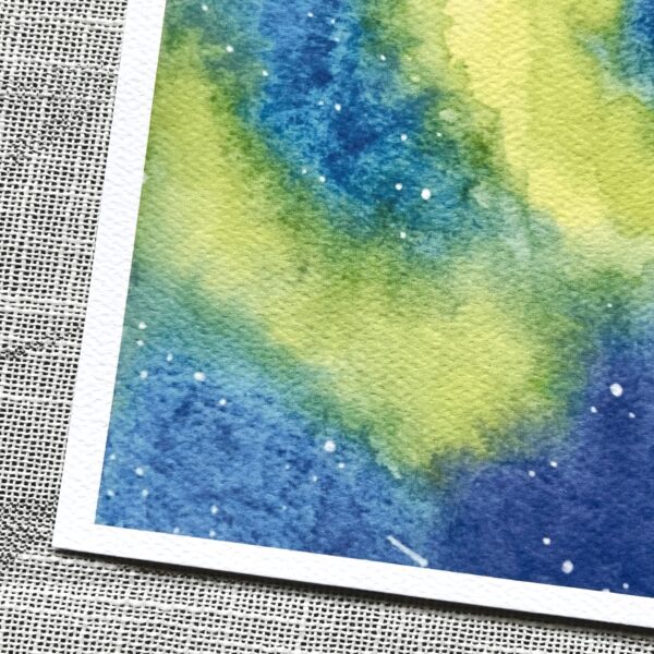 A close up of a print of Nikki's "Aurora Borealis 1" painting, printed on textured paper.