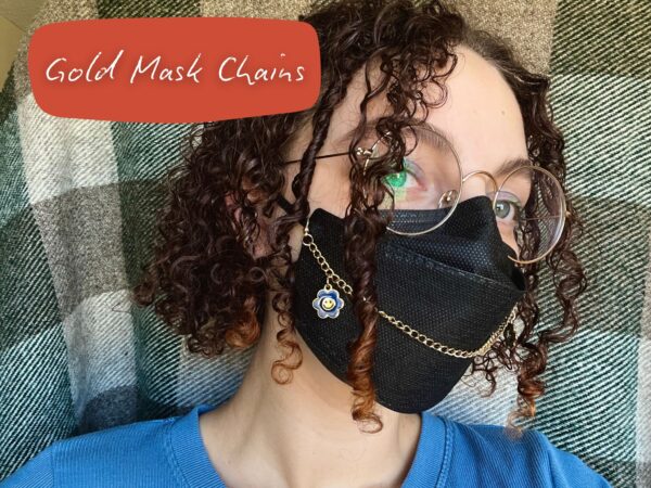 Nikki wearing a gold mask chain on a black N95 mask. There is a rectangle in the top left corner with black text that reads "Gold Mask Chains"