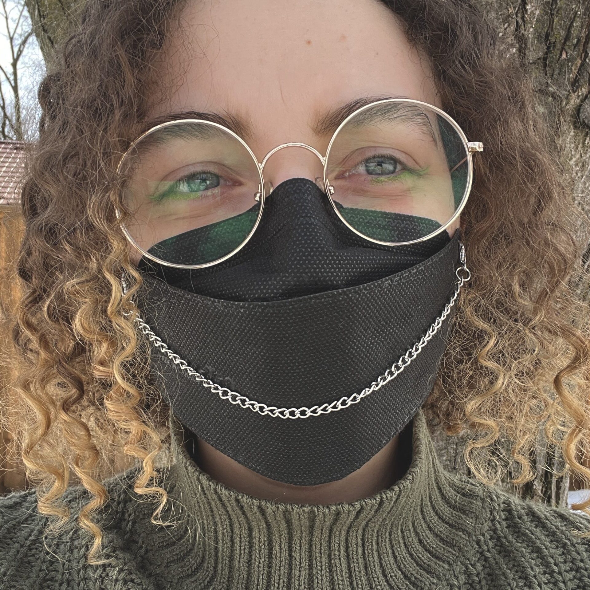 Nikki wearing a silver mask chain on a black KN95 mask.
